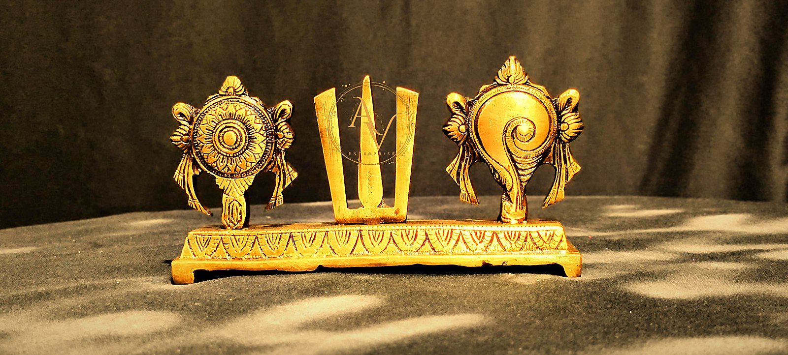 Handcrafted brass Shankh, Chakra and Namam set on dark fabric, made by Indian artisans